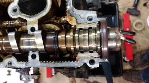 2007 Subaru Impreza - Close-up of an engine's camshaft, showing wear and oil accumulation.