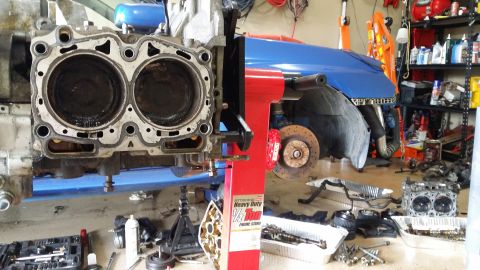 2007 Subaru Impreza - Disassembled engine block and surrounding car components in a workshop setting.