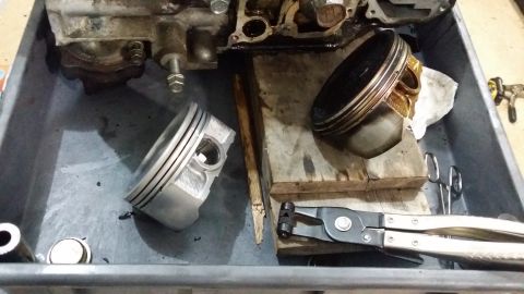 2007 Subaru Impreza - Engine components, including pistons, are laid out in a tray with tools for inspection or repair.