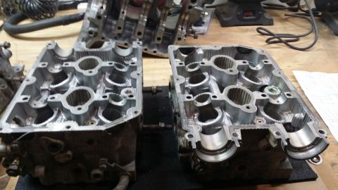 2007 Subaru Impreza - Two engine cylinder heads are shown disassembled on a workbench, with a Supermotors logo visible in the lower right corner.
