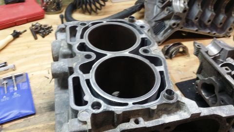 2007 Subaru Impreza - Disassembled engine block and parts on a workbench, likely for repair or rebuild.