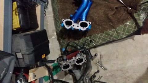 2007 Subaru Impreza - Engine intake manifold and associated parts laid out on a patterned tarp, possibly for a rebuild or modification.