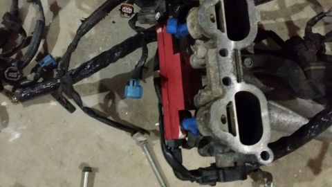 2007 Subaru Impreza - Close-up of an engine intake manifold assembly with fuel injectors and wiring harness.