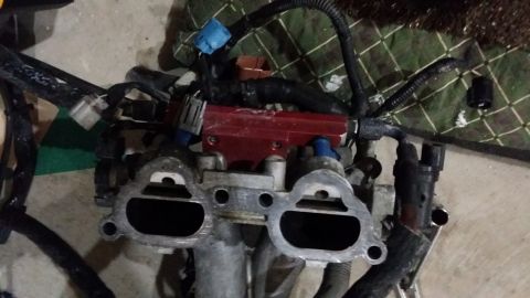 2007 Subaru Impreza - Close-up of an engine's intake manifold assembly, showing fuel injectors and associated wiring.