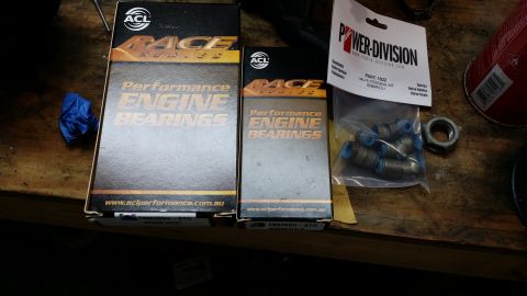 2007 Subaru Impreza - Engine parts including ACL performance engine bearings and Power-Division valve stem seals for a Subaru are laid out on a wooden surface.