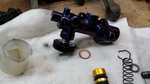 2007 Subaru Impreza - Disassembled brake master cylinder components are ready for cleaning or replacement.