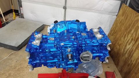 2007 Subaru Impreza - A bright blue engine block is mounted on a red stand, likely awaiting installation or further work.