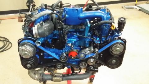 2007 Subaru Impreza - Engine assembly, painted blue, is shown on a stand with various belts and hoses attached.