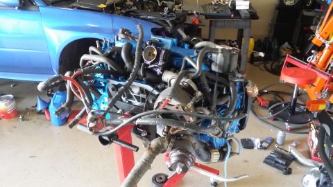 2007 Subaru Impreza - Engine removed from a blue Subaru, possibly for a build or repair.