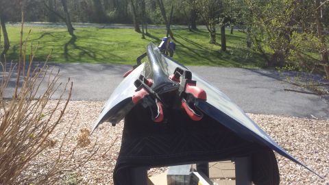 2007 Subaru Impreza - A car hood is shown resting on a stand, secured with red clamps, in an outdoor setting.