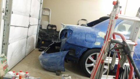 2007 Subaru Impreza - A blue 2007 Subaru Impreza is seen in a garage with its rear bumper detached, indicating ongoing bodywork.