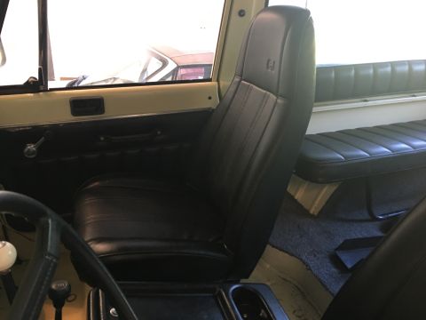 1986 Jeep Wagoneer - Interior view of a vehicle, showing black leather seats and door panel details.