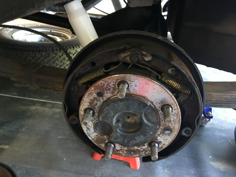 1986 Jeep Wagoneer - Close-up of a vehicle's rear drum brake assembly, showing brake shoes and springs.