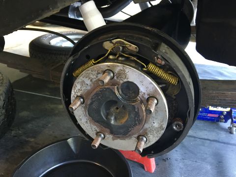 1986 Jeep Wagoneer - Close-up of a vehicle's rear drum brake assembly, showing internal components and wear.