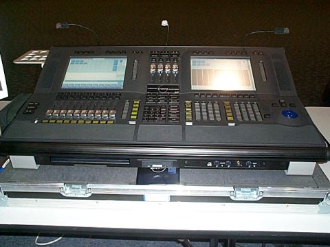 1994 Ford Bronco - A complex lighting control console with multiple faders and screens is displayed on a table.