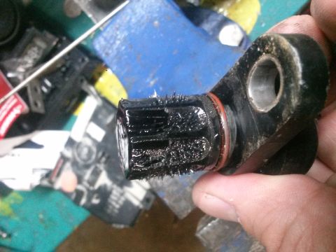 1996 Ford Bronco - A speed sensor is covered in metal shavings, indicating potential internal wear or external wear.