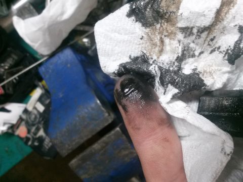 1996 Ford Bronco - A greasy finger and a stained paper towel suggest a recent mechanical task, possibly related to VSS issues.