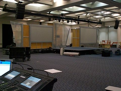 1994 Ford Bronco - A large conference room is being set up with a stage, screens, and audio equipment.