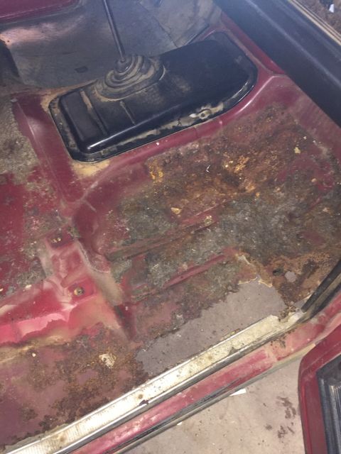 1978 Ford Bronco - The floor of this vehicle shows significant rust damage, particularly around the transmission tunnel.