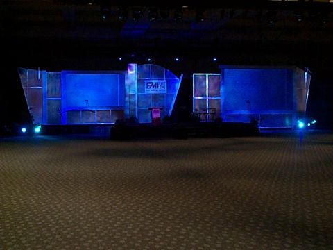 1994 Ford Bronco - A stage setup with blue lighting and a podium is visible in a dark room.