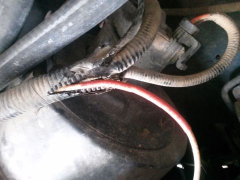 1996 Ford Bronco - Damaged wiring harness shows exposed red wire, indicating a potential electrical issue.