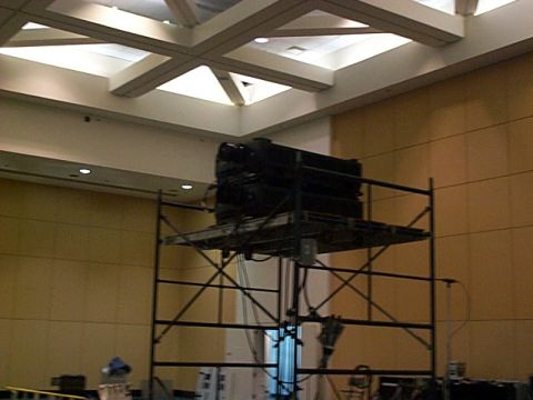 1994 Ford Bronco - Black equipment stacked on scaffolding in a large indoor space with a skylight.