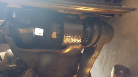 1996 Ford Bronco - Close-up view of a vehicle's steering linkage component.