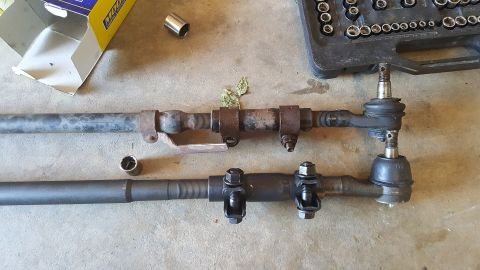 1996 Ford Bronco - Comparison of an old and new steering linkage, with tools laid out on the ground.