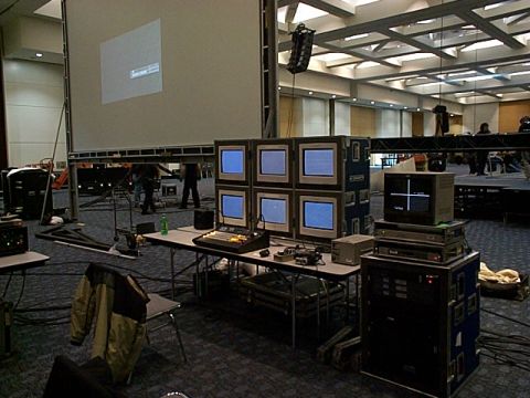 1994 Ford Bronco - A large projection screen and various video monitors are set up in a spacious hall, likely for an event or presentation.