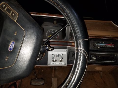 1988 Ford Bronco - Aftermarket switches are installed on the dashboard, controlling various functions within the vehicle's interior.