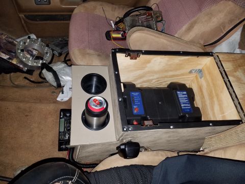 1988 Ford Bronco - Interior view of a custom center console modification with a battery and radio.