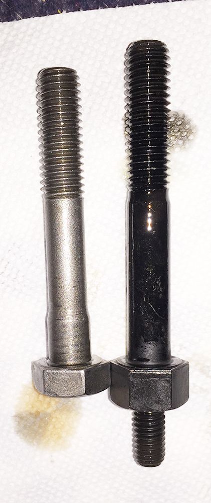 1978 Ford Bronco - A comparison of two bolts, one showing wear and the other coated in black, is presented on a white background.