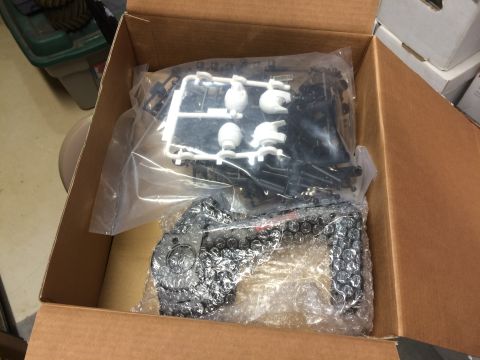 1989 Ford Bronco - Unassembled model car parts are shown in a cardboard box, ready for assembly.