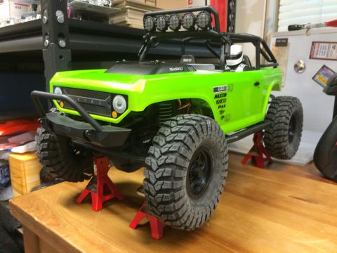 1989 Ford Bronco - This RC rock crawler truck is painted bright green and sits on jack stands.