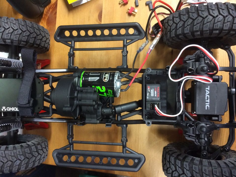 RC car chassis with green motor, black gearbox, and Tactic receiver