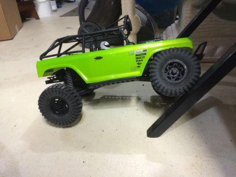 1989 Ford Bronco - This RC rock crawler features a bright green body, a protective roll cage, and Maxxis tires, suggesting off-road capabilities.