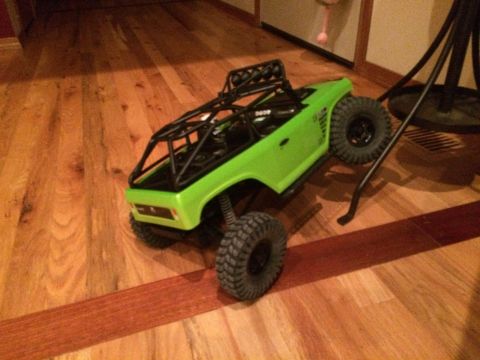 1989 Ford Bronco - This remote-controlled rock crawler sits on a polished wooden floor, ready for action.