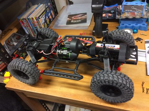 1989 Ford Bronco - This is a close-up view of an RC rock crawler's chassis, showing its suspension, motor, and battery.