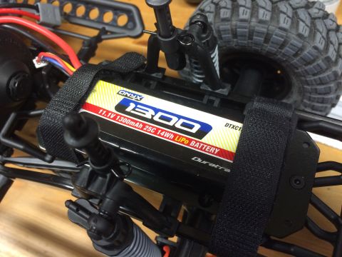 1989 Ford Bronco - Close-up of an RC car's battery pack and suspension components.