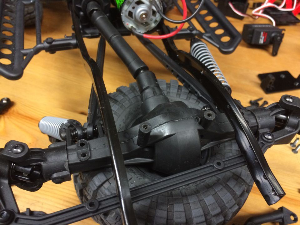 Close-up of RC car rear axle, differential, shock, and tire.