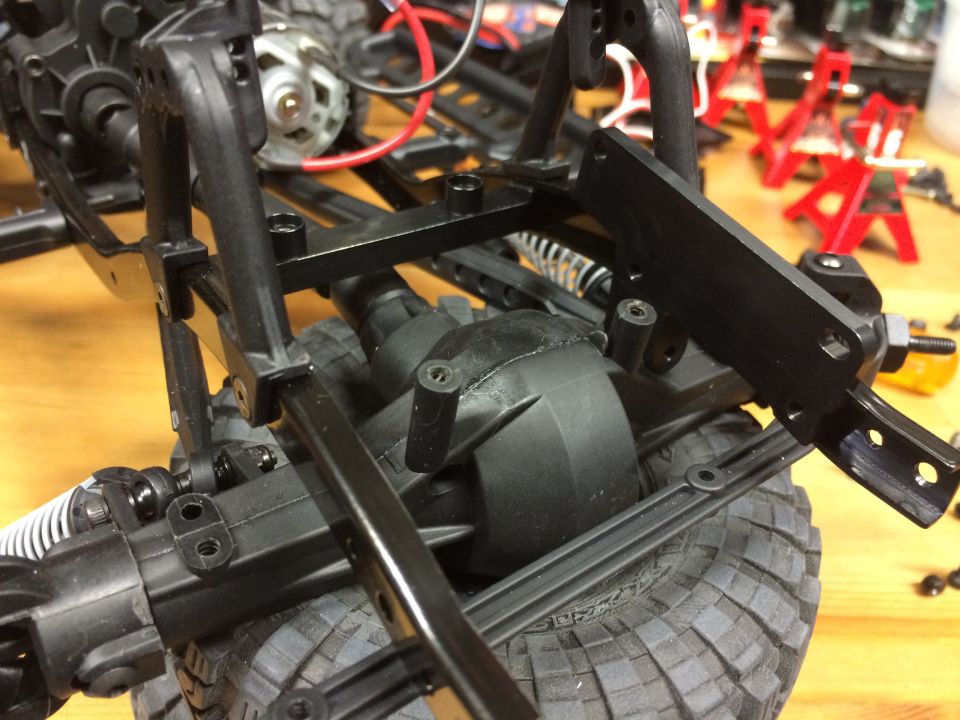 Close-up of RC car rear axle, suspension, and tire.
