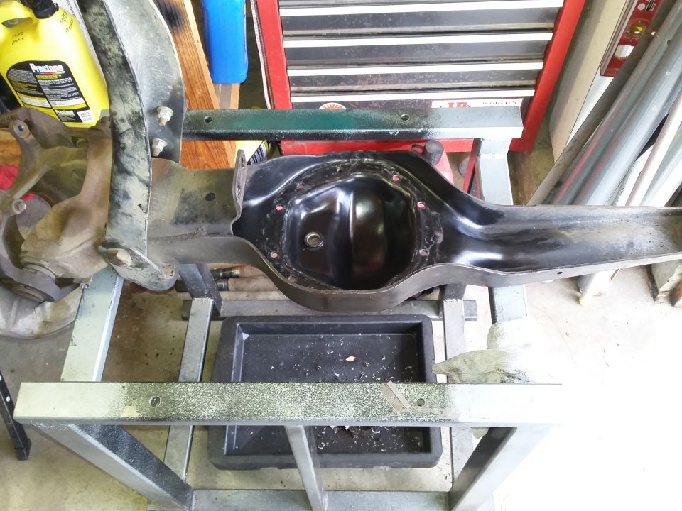 Black differential housing assembly on a metal stand.