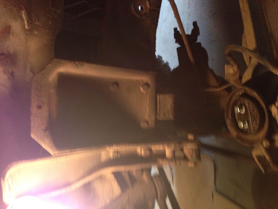 Underside vehicle part, possibly transmission or suspension component, with electrical connector.
