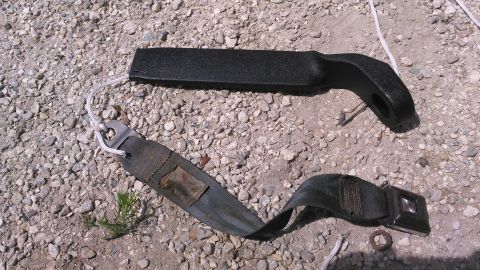 1990 Ford F-250 - tie the rope to the metal tab. feed the belt in. make sure the buckle is facing the correct direction.