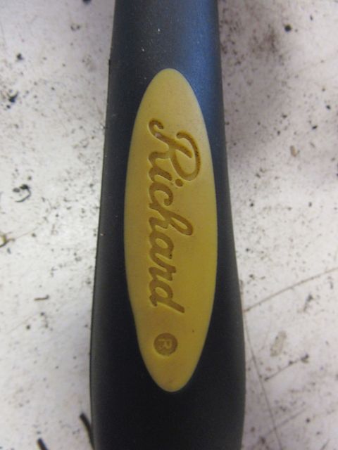 Black tool handle with yellow oval insert embossed with "Richard" and a registered trademark symbol