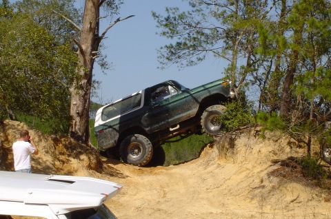 1993 Ford Bronco - Ford Bronco tackling an off-road trail, with another vehicle in the foreground.