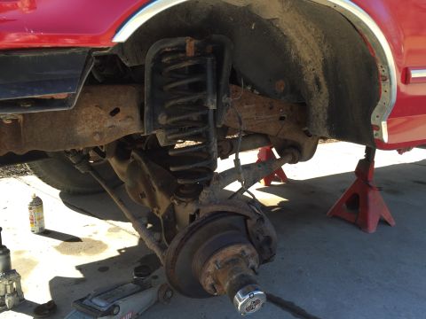 1996 Ford F-150 - Front suspension work on a 1996 Ford F-150, showing the coil spring and brake components.