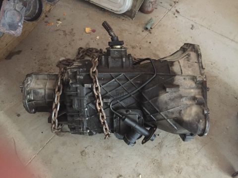 1967 Ford Custom Wagon - A used transmission is shown on a concrete surface, secured with a metal chain.