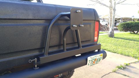 1978 Ford Bronco - Aftermarket rear bumper and spare tire carrier assembly, with a Florida license plate.
