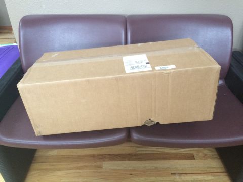 1989 Ford Bronco - A cardboard box sits on a bench, obscuring any potential vehicle details.